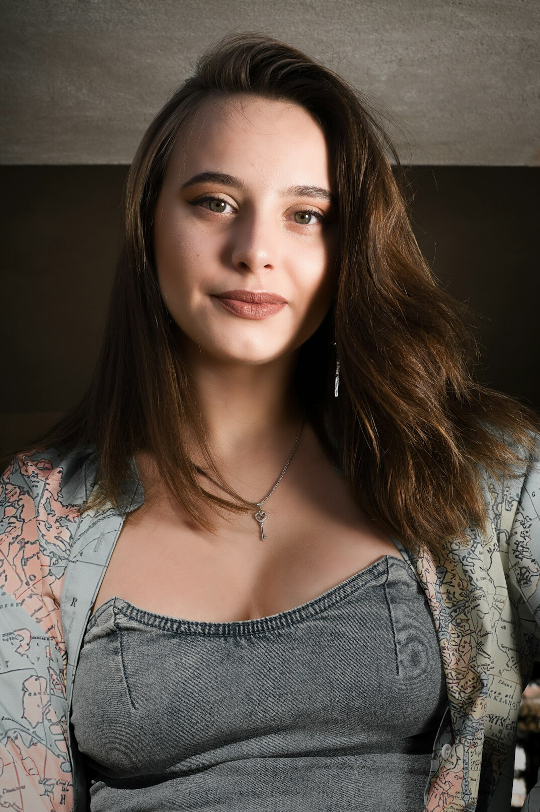 Studio portrait of a European woman in her thirties with shoulder length brown hair smiling